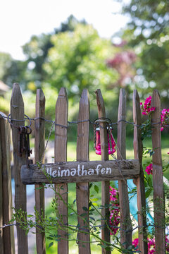 Wooden sign and old key ring hanging on rustic fence