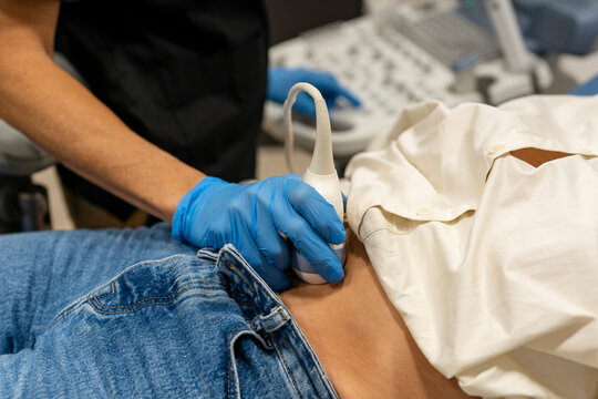 Doctor performing ultrasound examination on patient stomach