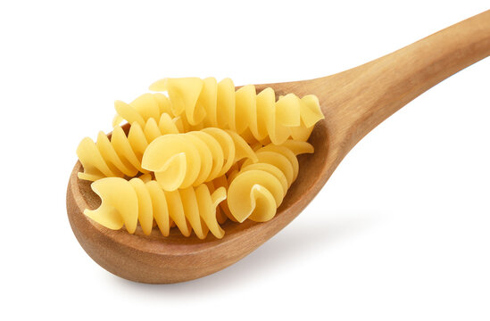 Raw pasta in a wooden spoon on a white background. Isolated.