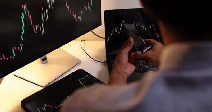 Professional trader analyzes live financial charts across desktop, laptop, tablet, and smartphone in a modern office, monitoring market trends, tracking investments, and making trading decisions.