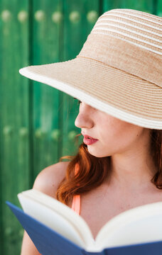 Young woman with book in summer