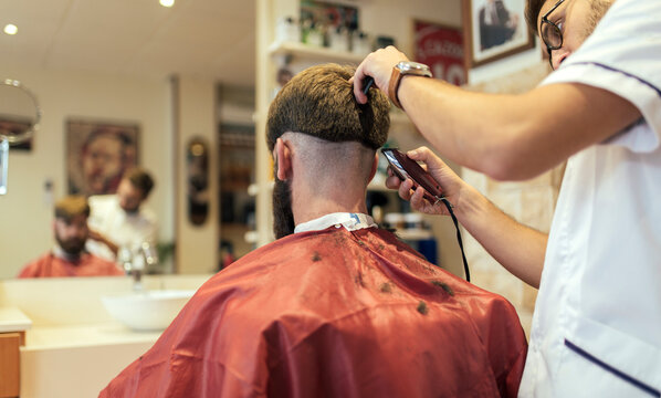 Barber shaving head of a customer
