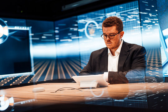 Businessman working at desk in modern television studio