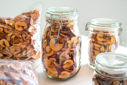 Glasses and vacuum-packed plastic bags of homemade apple chips
