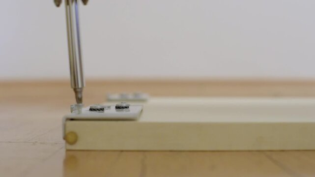 Adjusting vertical guide for door. Ensuring precise alignment of door guide with track edge. Carefully adjusting door edge guide to match track for smooth operation