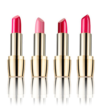 Row of four lipsticks in front of white background