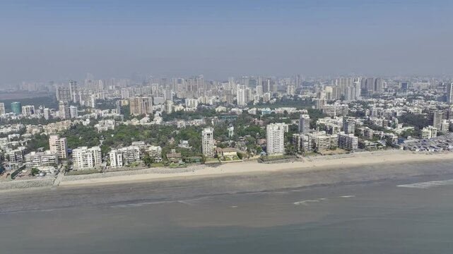 Mumbai skyline overlooking Versova Beach during golden hour aerial view,
Urban skyline and Versova Beach during sunset in Mumbai India

