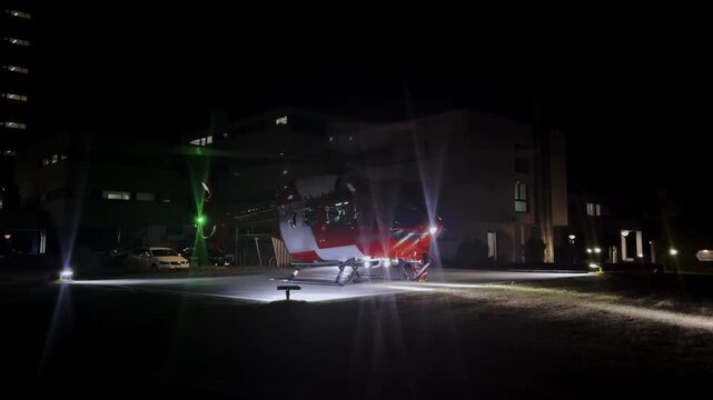 Night standby mode, rescue helicopter stationary on tarmac, ambient lighting, cinematic aviation shot, calm atmosphere, professional emergency vehicle