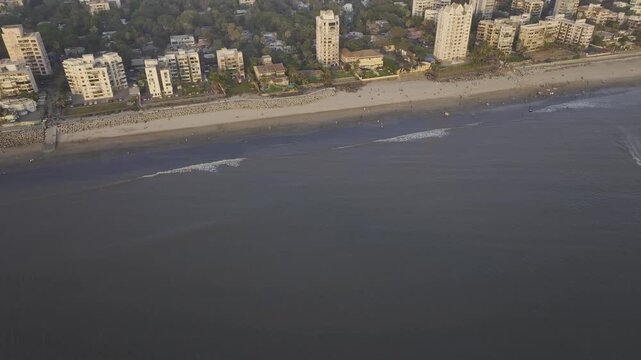 Aerial drone view of Versova Beach at sunset with Mumbai skyline India,
Golden hour aerial panorama of Versova Beach Mumbai Maharashtra

