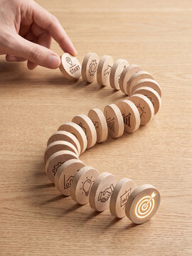 Business strategy and goal achievement concept with wooden dominoes arranged in a path
