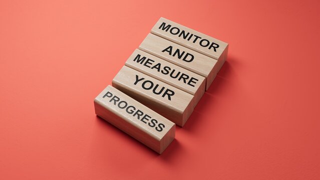 Monitor and Measure your Progress symbol. wooden blocks with words Monitor and Measure your Progress.Businessconcept.3D rendering