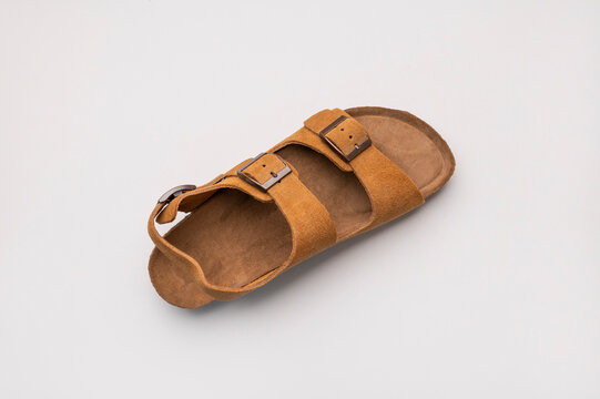 Stylish open sandal on light gray background, top view showcases minimalist design, seasonal trend, versatile appearance. Fashion concept supports branding, ecommerce visuals, commercial lifestyle 