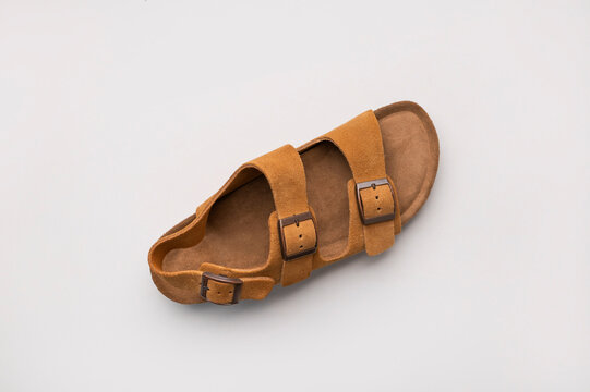 Classic brown sandals viewed from above highlight premium footwear with soft suede finish. Shoes support fashion marketing, online catalogs and lifestyle promotions with elegant minimalist aesthetic.