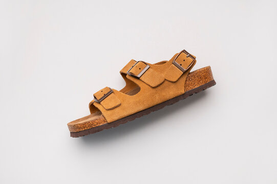 Classic brown sandals viewed from above highlight premium footwear with soft suede finish. Shoes support fashion marketing, online catalogs and lifestyle promotions with elegant minimalist aesthetic.