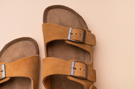 Classic brown sandals in macro view feature suede finish, sturdy sole and adjustable straps. Summer footwear delivers comfort, versatile styling and natural aesthetic for business and retail use.