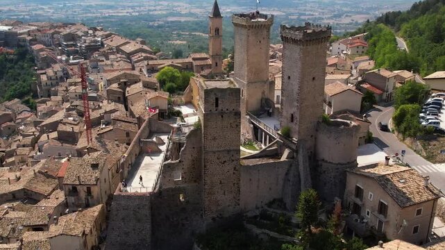 Pacentro Abruzzo Italy drone aerial view revealing medieval castle towers and ancient village background. Pull back sideways flyover stock video footage of historical borgo in Caldora