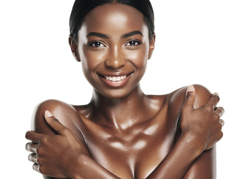 Smiling African American woman with radiant glowing skin in studio shot
