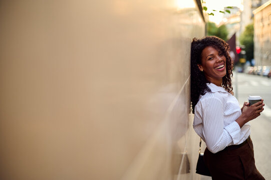African American Woman Smiling With Coffee In City Street, Casual Business Portrait For Marketing And Lifestyle