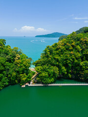 defaultAerial drone view of calm green lake bordering with blue sea scenery at Dayang Bunting Lake in Langkawi Island, Kedah, Malaysia. © MUAZ JAFFAR