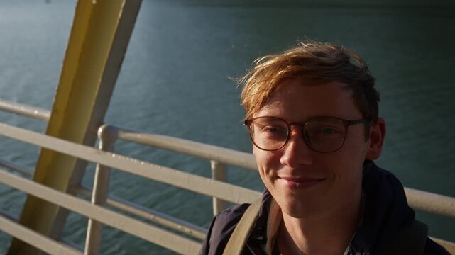 A Smiling Traveler Stands on a Boat With Calm Waters in the Background in Ha Long Bay, Quang Ninh Province, Vietnam. Close Up