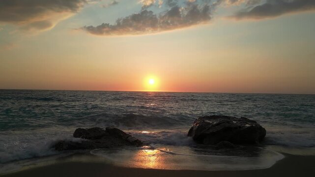 Golden sunset reflecting over breaking waves
