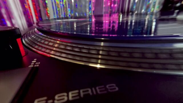 Slow Motion Side View of Blue Vinyl Disc Spinning on Turntable