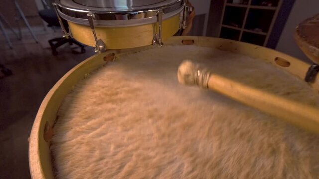 Slow Motion Strong Mallet Hits on Furry Drum Head of Traditional Bombo Leguero Drum