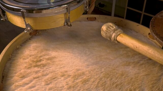 Mallet Hitting Furry Drum Head of Traditional Bombo Leguero Drum, Close Up