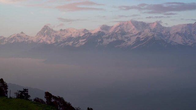 Dayara Bugyal Uttarakhand India. Bandarpoonch, Draupadi Ka Danda and other Gangotri Glacial Peaks. Snowy mountain peaks above layered blue hills