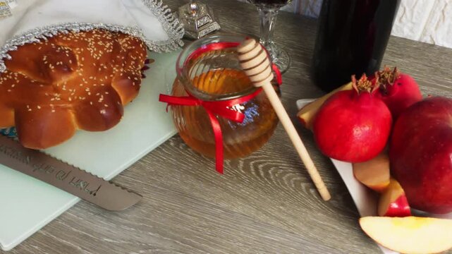 Rosh hashanah table with honey, apple and challah bread