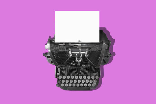 Pink vintage typewriter with a white sheet of paper. Concept for writing and sending a message.