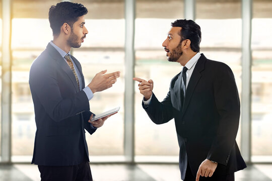 Corporate employees in formal business suit talking  with one of them holding digital tab.