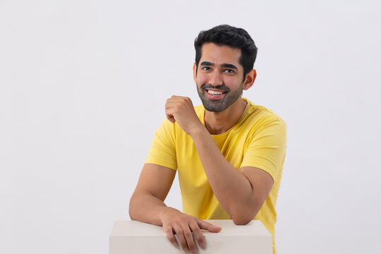 Happy young man looking at the camera with smile 