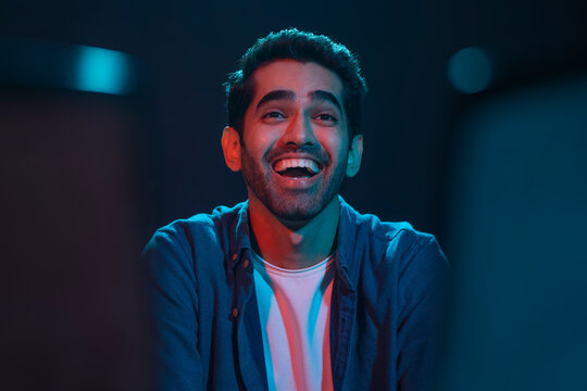Adult man having fun while watching comedy movie in the movie theater