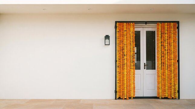 Minimalist Diwali Entrance Decoration with Marigold Garlands on White Door, Festive Home Decor Background