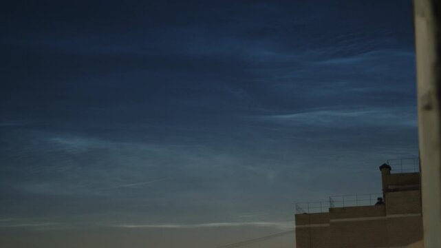 Noctilucent clouds or NLC in the summer sky on the northern hemisphere, on 56,5 degrees of latitude.
