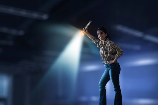 Young girl searching down with torch light