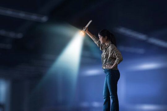 Young girl searching down with torch light
