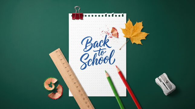 Minimal back to school education background with notebook, pencils, ruler, eraser, sharpener and autumn maple leaf on green chalkboard, representing learning, preparation and academic success.