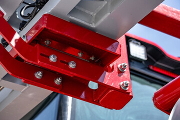 Naklejka premium Agricultural machinery metal frame heavy bolt joint with nuts. Modern farm machine steel chassis construction fastener component and industrial vehicle engineering structural detail for tractor.