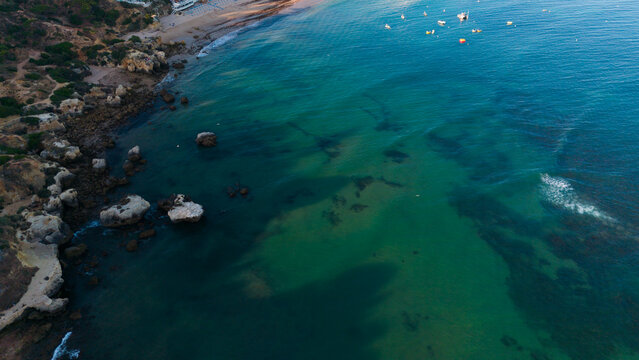 serene beach and coastline aerial view with rock formations and sandy shores in a relaxed coastal landscape, travel and tourism real estate context, blue and green hues. Praia dos Aveiros Portugal