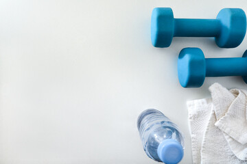 Obraz premium Blue Dumbbells with Towel and Water Bottle