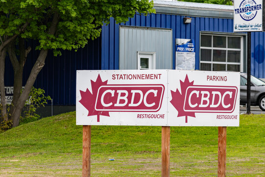 Campbellton, New Brunswick, 06 June 2026 : A CBDC Restigouche parking sign stands before a car wash business.