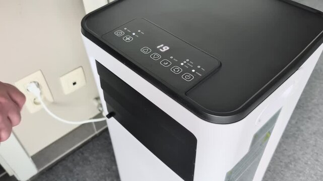 Adjust the temperature and air direction flaps on a portable room air conditioner for better cooling