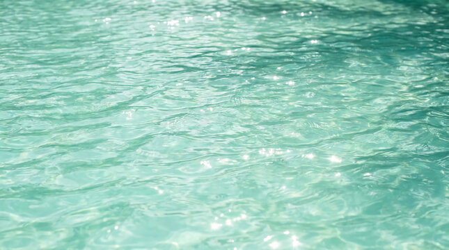 Clear turquoise water surface with gentle ripples reflecting light.