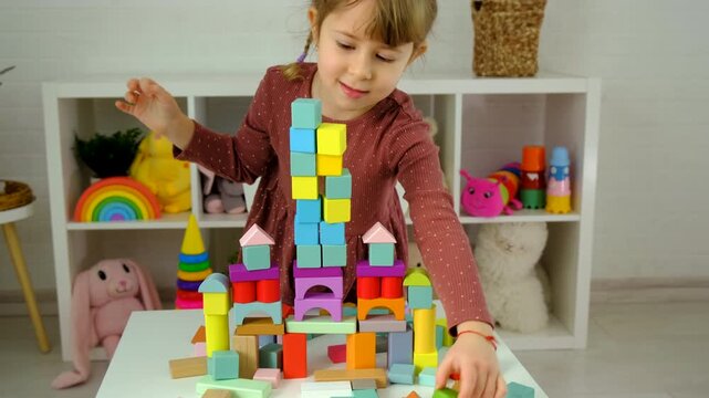 A child plays with wooden blocks. Selective focus.