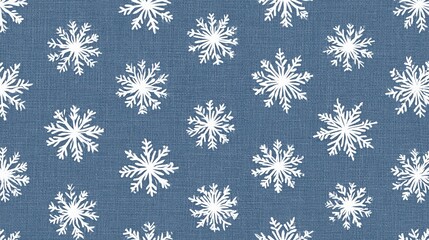 Fototapeta premium Delicate white snowflake pattern on a textured blue denim background, perfect for winter holidays and cozy seasonal designs
