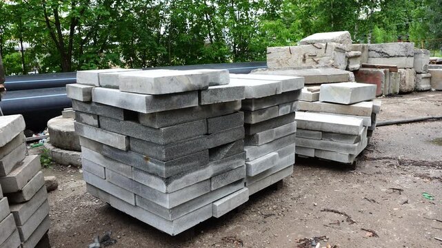 Stacked natural stone slabs prepared for construction landscaping and architectural projects at outdoor material storage area