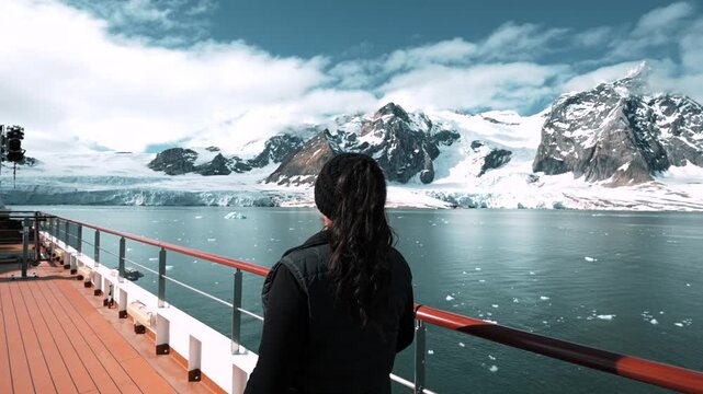 A Girl Enjoys Stunning Views From A Ship In Svalbard While Exploring Glaciers.