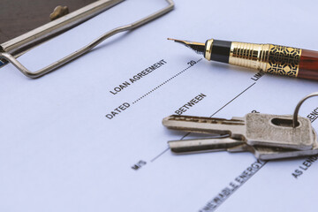 Fototapeta premium Loan Agreement with House Keys and Fountain Pen for Mortgage and Lending Concept